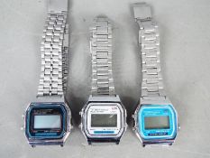 Three vintage digital wristwatches with stainless steel straps.