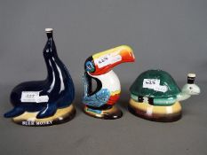 Breweriana - a Guinness ceramic jug in the form of a toucan and two money banks,