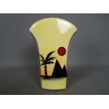 Lorna Bailey - a vase with flared arch top decorated in the Pyramids pattern, signed to the base,