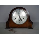 An oak cased Smiths mantel clock with key and pendulum.