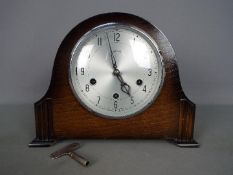 An oak cased Smiths mantel clock with key and pendulum.