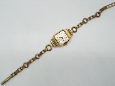 A lady's 18ct gold cased Swiss wristwatch, Swiss hallmarks, on plated bracelet.