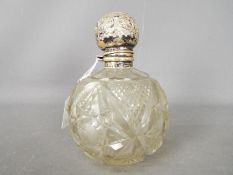 A large, George V silver topped cut glass scent bottle, Birmingham assay 1910,