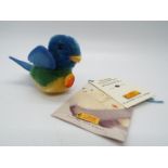 Steiff - a mohair Steiff blue bird entitled Lora with tag on breast, button and yellow label,