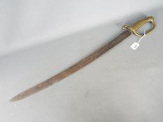 A late 19th century naval cutlass with 67 cm steel blade, with ribbed brass handle,