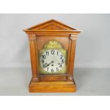 An oak cased bracket clock with Westminster Chime,