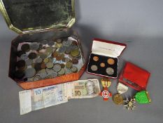 A quantity of UK and foreign coins and bank notes, Red Cross Nursing Proficiency medal,