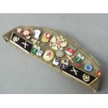 A collection of Soviet Russian badges displayed on a Russian military beret together with three