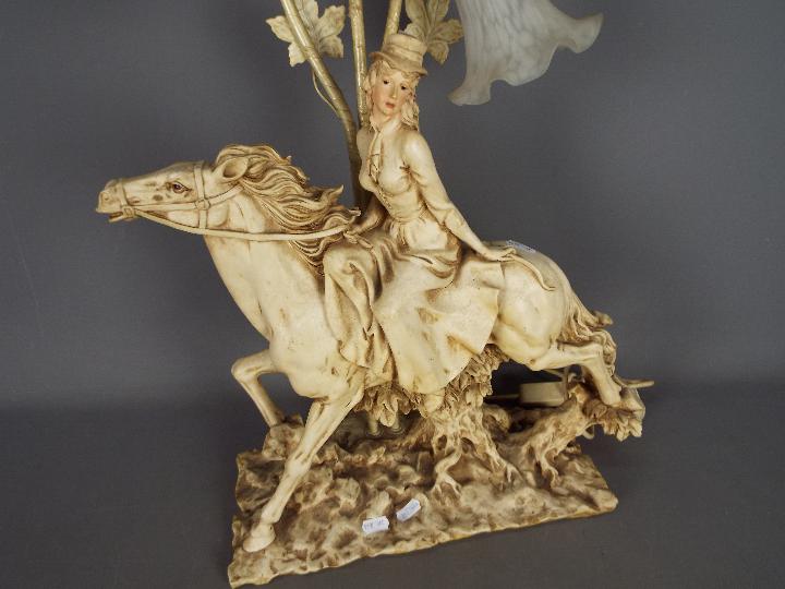 A decorative three stem table lamp in the form of a lady on horseback, - Image 2 of 3