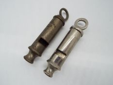 An Acme City Whistle and a Metropolitan whistle.