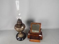 A Lampe National oil lamp and a good quality wood framed dressing table or shaving mirror.