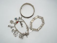 A charm bracelet with eleven continental charms, variously stamped 800, 835 etc,