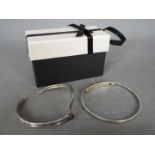 Two silver bangles,