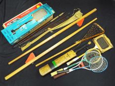 A collection of vintage sporting equipment and games to include a Hardys fishing rod,