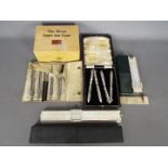 A vintage Boots Pure Drug Co Home First Aid Case (with contents), technical drawing set,