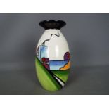 Lorna Bailey - a Lorna Bailey vase decorated with an Art Deco house,