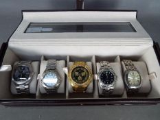 A watch display box containing five wrist watches