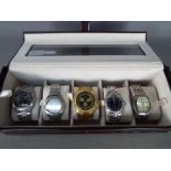 A watch display box containing five wrist watches