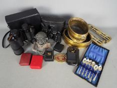 A mixed lot of collectables to include a vintage money bank, brassware, binoculars,