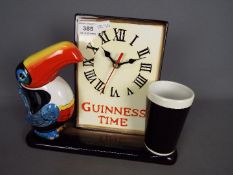 Breweriana - A ceramic Guinness advertising clock with toucan and pint glass,