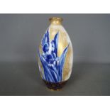 A Royal Doulton vase decorated with blue iris, gilt and white ground, green backstamp, # C8288,