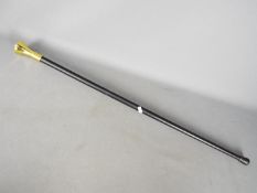 A walking stick with a Masonic handle logo