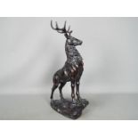 A large sculpture depicting a stag on a rock,