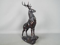 A large sculpture depicting a stag on a rock,