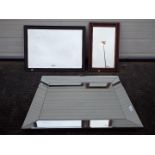 Three wall mirrors, two having wooden frames, largest approximately 91 cm x 70 cm.