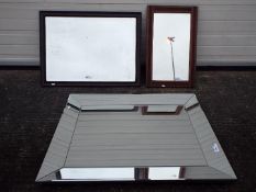 Three wall mirrors, two having wooden frames, largest approximately 91 cm x 70 cm.