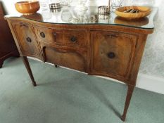 A good quality serpentine front sideboard with protective glass top,