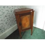 A small form side cupboard with protective glass top, raised on four supports,