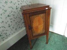 A small form side cupboard with protective glass top, raised on four supports,