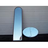 Two wall mirrors comprising an oval example (41 cm x 66 cm) and one other (130 cm x 34 cm) [2]
