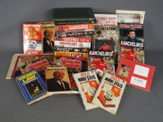 Manchester United - two boxes containing a large collection of memorabilia, books, yearbooks,