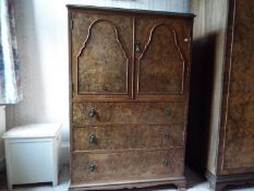 A walnut veneered cupboard over three drawers, originally purchased from Harrods,