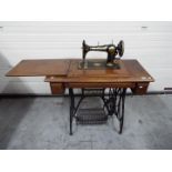 A vintage Jones treadle sewing machine on cast iron base,
