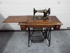 A vintage Jones treadle sewing machine on cast iron base,