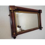 A small wood framed over mantel mirror with carved detailing, approximately 52 cm x 78 cm.