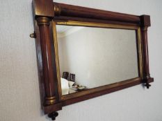 A small wood framed over mantel mirror with carved detailing, approximately 52 cm x 78 cm.