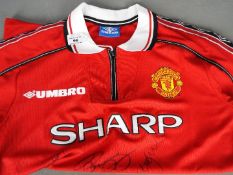 Manchester United - A reproduction 'Treble' shirt with multiple signatures including Teddy