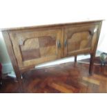 An oak sideboard raised on four supports, each with castor,