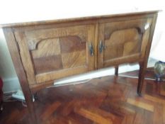 An oak sideboard raised on four supports, each with castor,