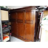 A large triple door wardrobe with carved detailing,