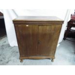A vintage twin door cabinet raised on four supports, approximately 88 cm x 73 cm x 38 cm.