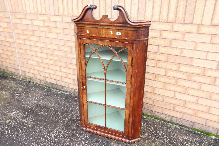 A George III mahogany bow-fronted hanging corner cupboard with broken swan-neck pediment above an - Image 2 of 3