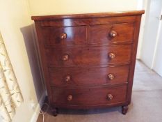 A substantial bow fronted chest of two over three drawers, raised on four turned supports,