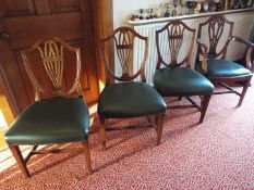 Three dining chairs and a carver.