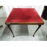 A folding card table with fabric top, approximately 66 cm x 76 cm x 76 cm.