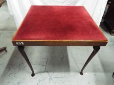 A folding card table with fabric top, approximately 66 cm x 76 cm x 76 cm.